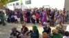 People line up in front of a Turkmen state grocery store to buy cooking oil. (file photo)