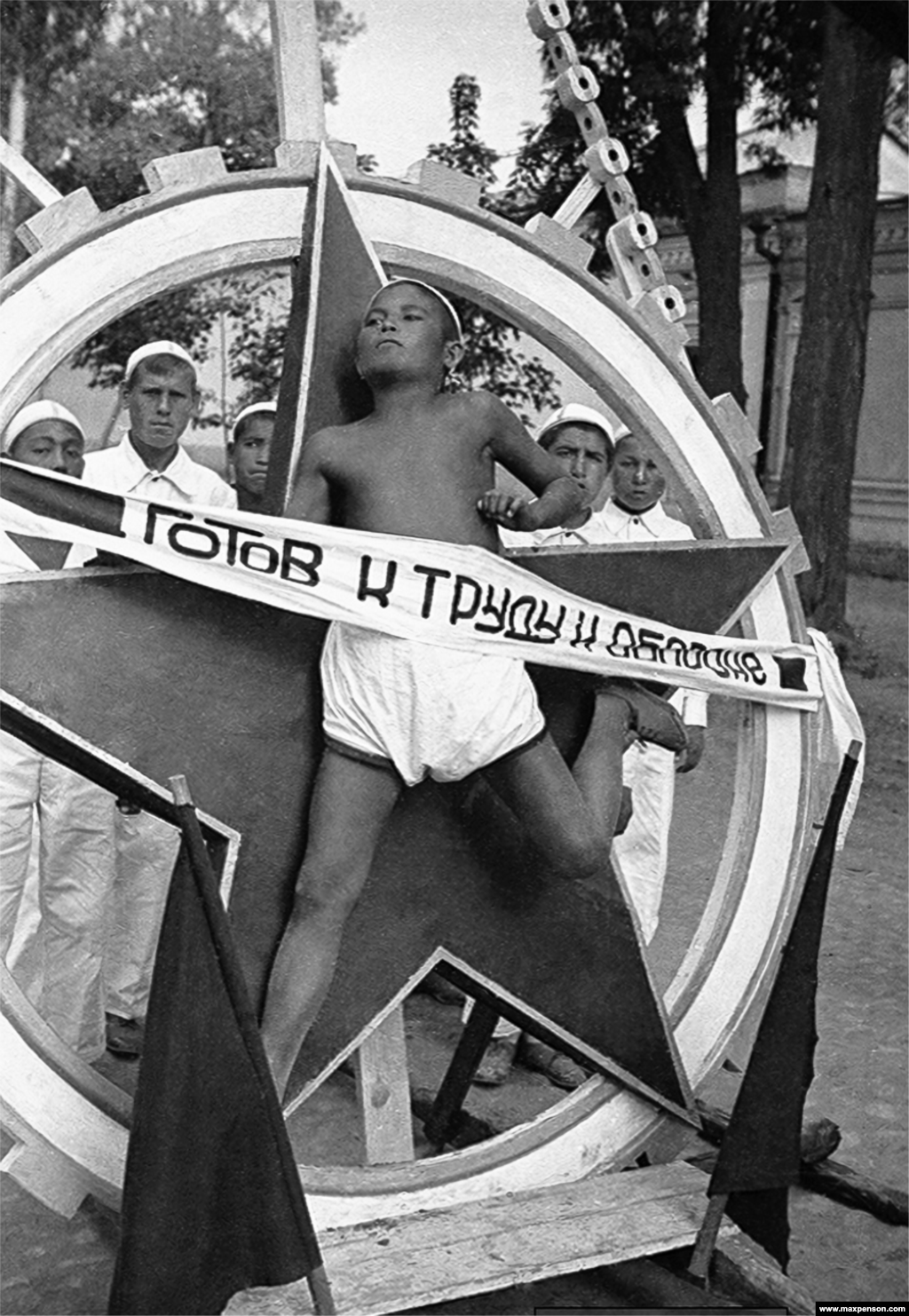 A boy is used as a "live emblem" in a socialist march in central Tashkent.The banner proclaims a readiness "for labor and defense!" Today, Penson’s archive is managed by his grandson Maxime Penson who lives in Tashkent.
