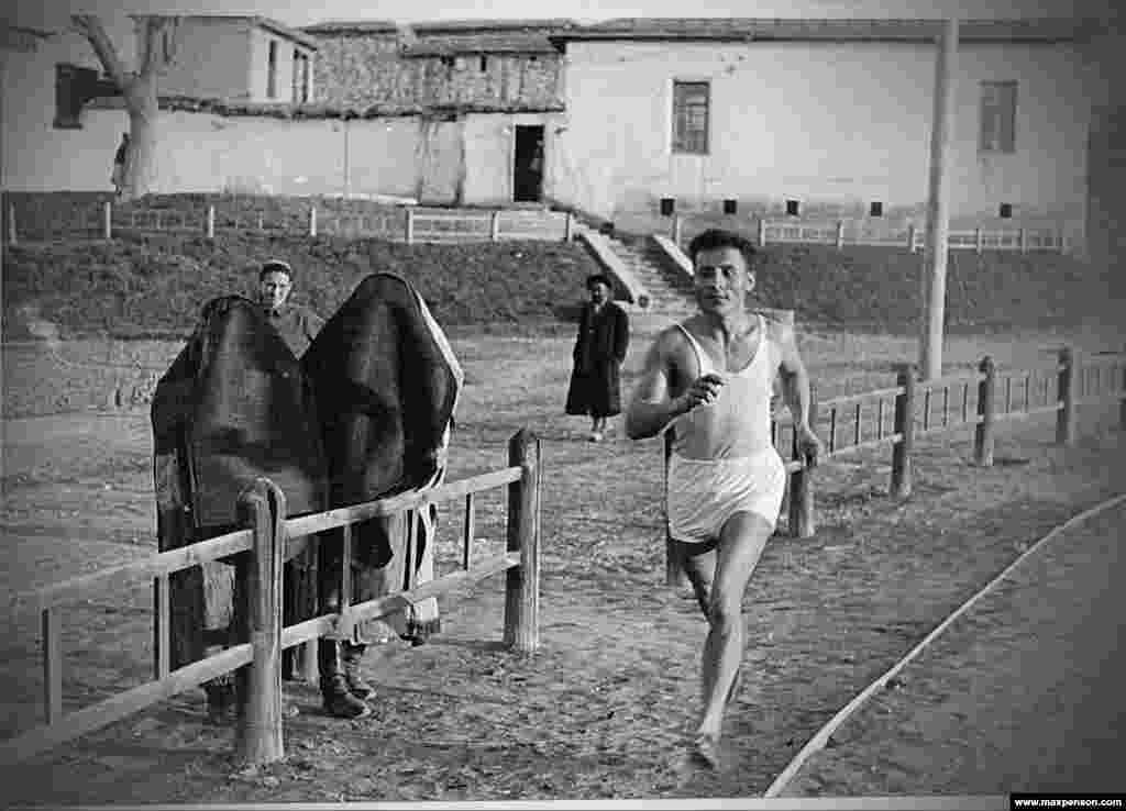 A sportsman runs past women in burqas during the first years of Soviet Uzbekistan.Early images of Soviet Uzbekistan are rare, but photographer Max Penson was there, on the farms and in the bazaars during the Soviet republic’s first days.