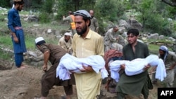 Afghans carry the deceased for a funeral ceremony in Mazar Dara village in the Nurgal district of Kunar Province in eastern Afghanistan on September 1.
